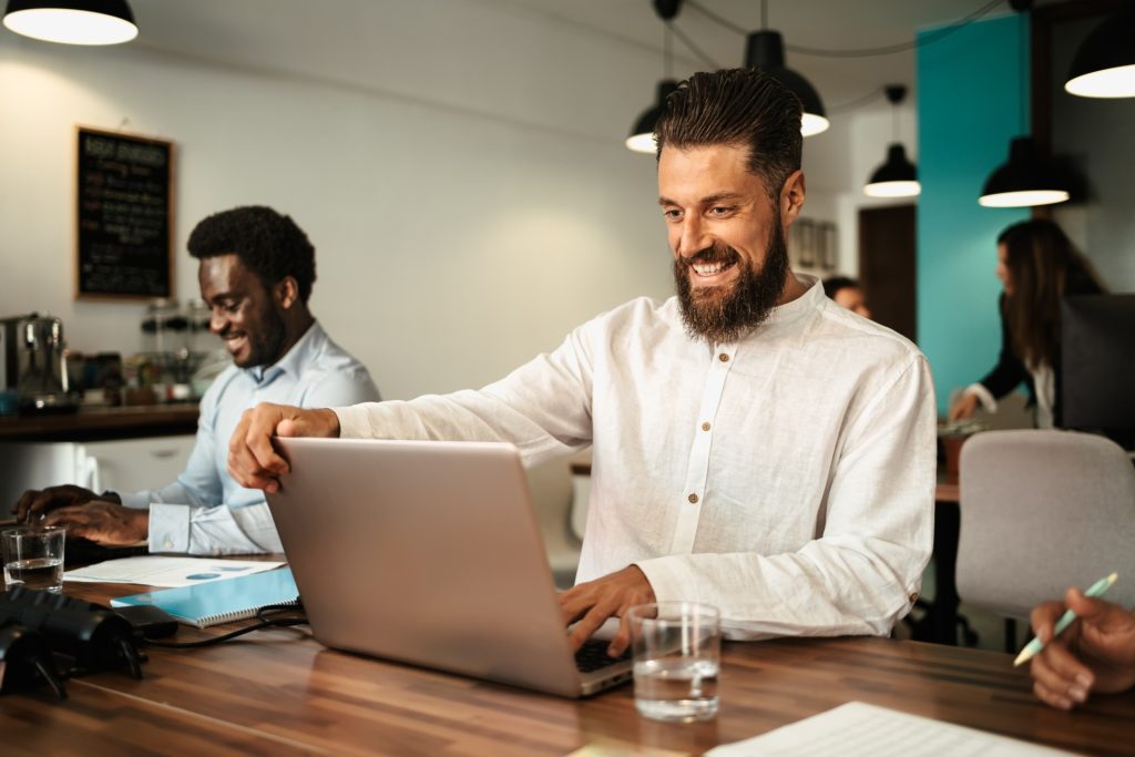 Multiracial people working inside coworking creative space